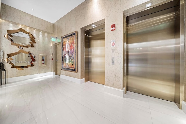 bathroom featuring wallpapered walls and elevator