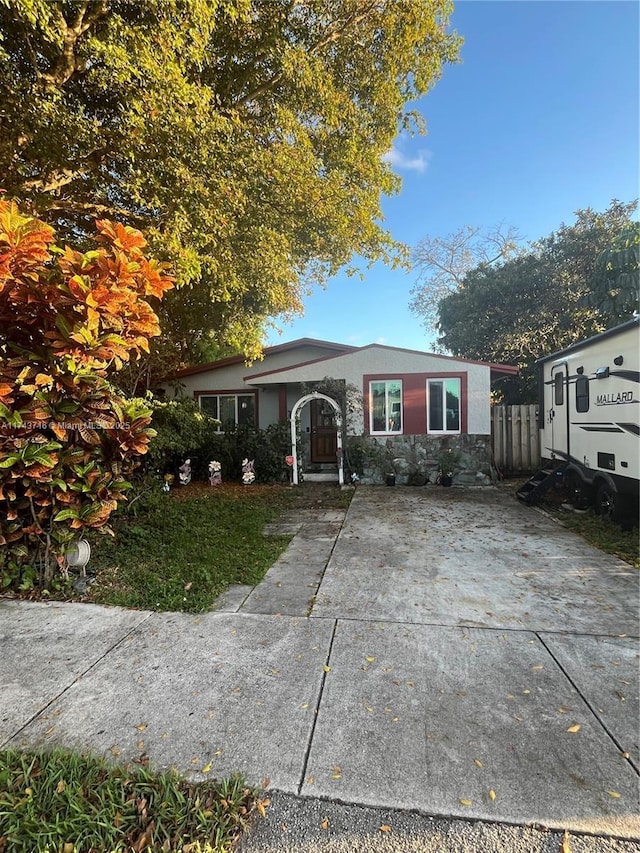 view of front facade featuring fence and stucco siding