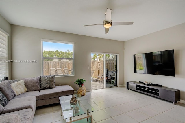 tiled living room featuring ceiling fan and plenty of natural light