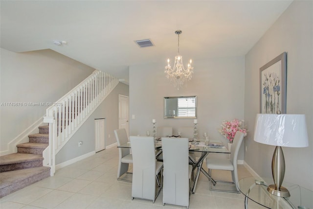 dining area featuring light tile patterned floors and a notable chandelier