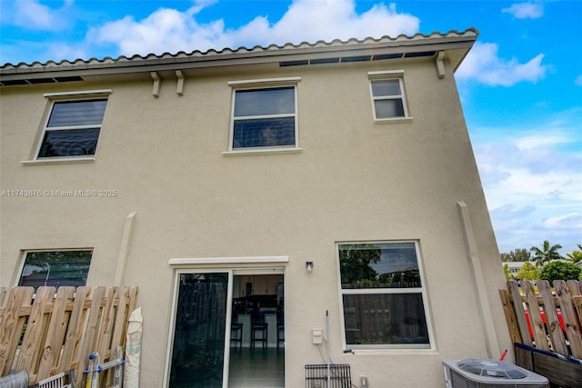 back of house featuring central AC