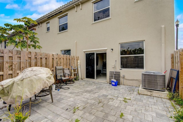 back of property featuring a patio area and central air condition unit