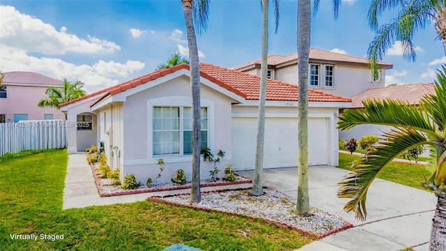 back of house featuring a garage and a lawn