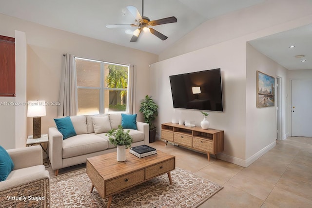 living room featuring ceiling fan, light tile patterned floors, and lofted ceiling