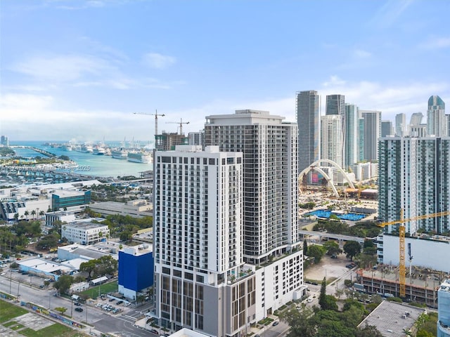 birds eye view of property featuring a water view and a city view