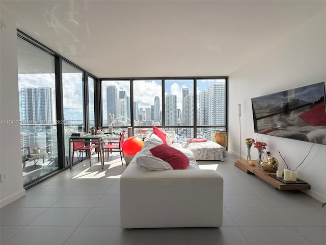 tiled living room featuring floor to ceiling windows