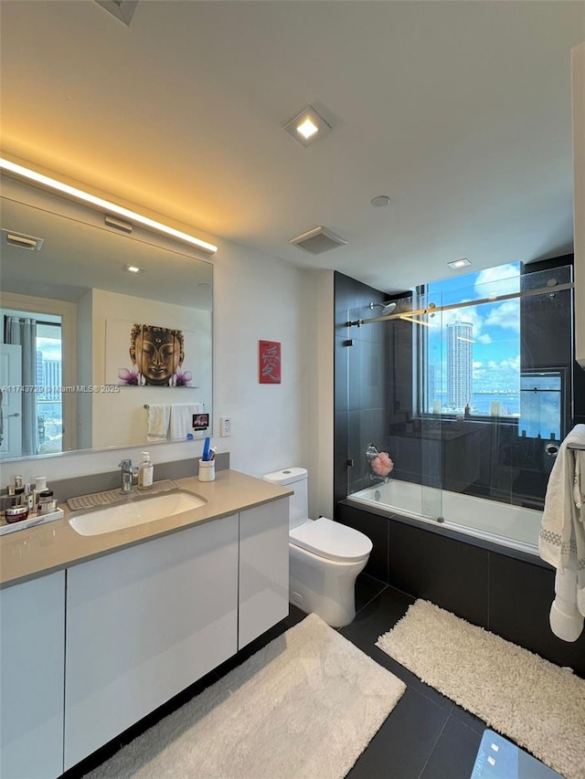 full bathroom featuring vanity, tile patterned flooring, a wealth of natural light, and enclosed tub / shower combo