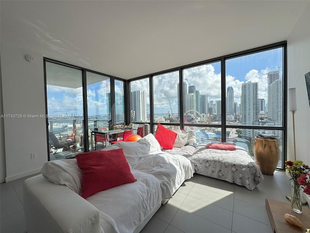 bedroom with tile patterned flooring, a wall of windows, and access to outside