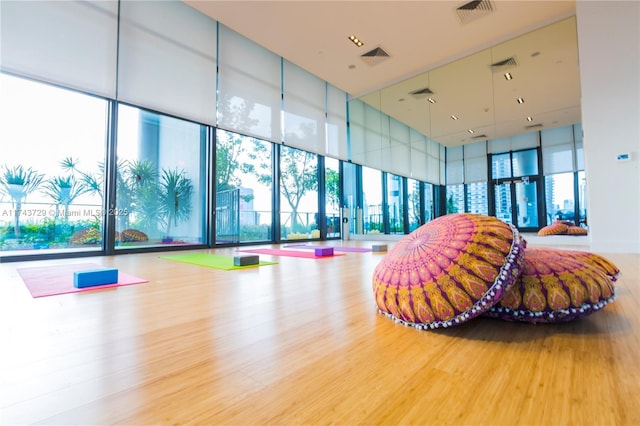 interior space featuring visible vents, wood finished floors, and a healthy amount of sunlight