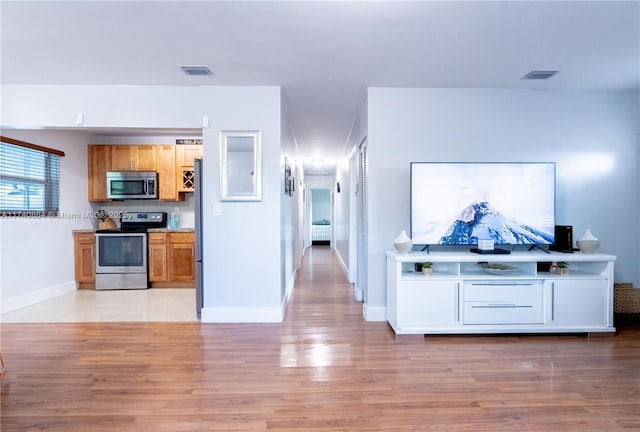 kitchen featuring light wood-style floors, visible vents, stainless steel appliances, and light countertops