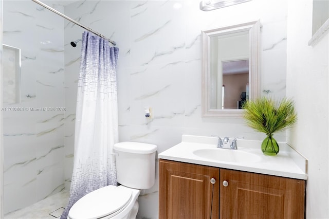 bathroom with a stall shower, tile walls, vanity, and toilet