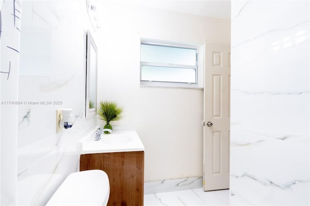 bathroom featuring marble finish floor and vanity