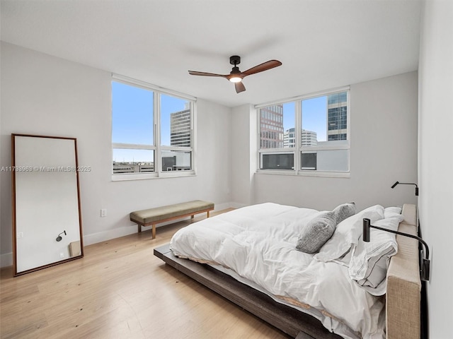 bedroom featuring light hardwood / wood-style floors and ceiling fan