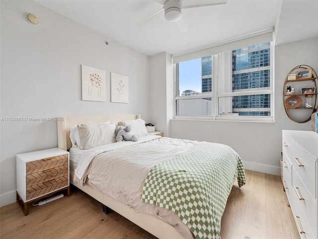 bedroom featuring light hardwood / wood-style flooring and ceiling fan