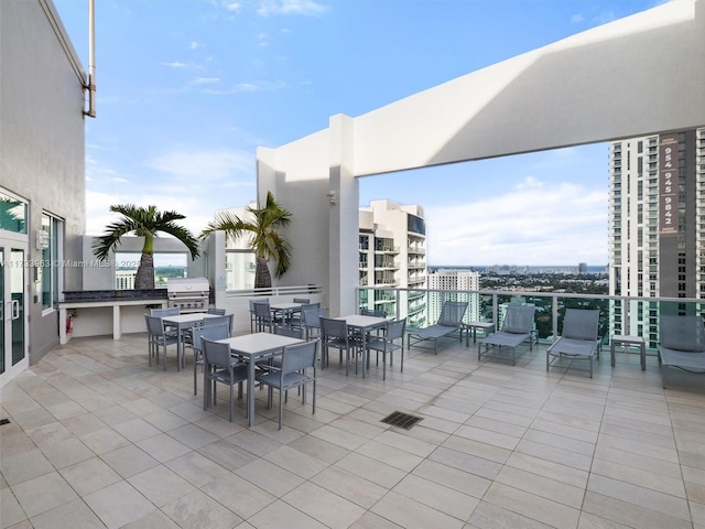 view of patio featuring area for grilling and a grill