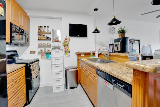 kitchen with sink, black appliances, ceiling fan, and light stone countertops