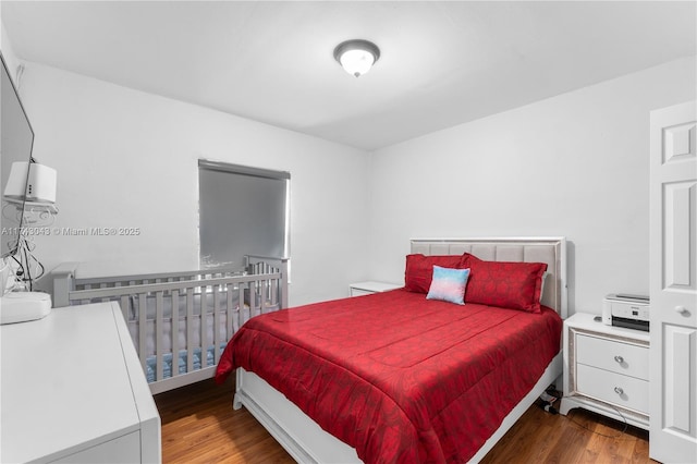 bedroom with dark hardwood / wood-style floors