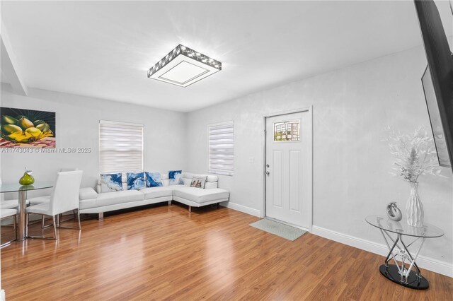 living area featuring light wood finished floors and baseboards
