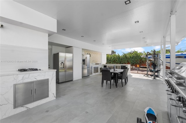 view of patio featuring outdoor dining space, a grill, and area for grilling