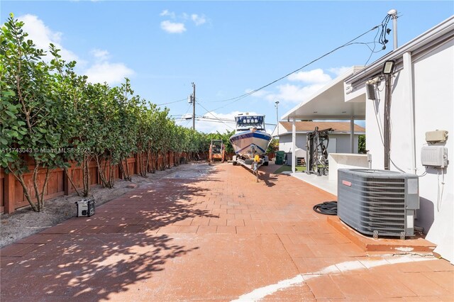 view of patio / terrace featuring fence and central air condition unit