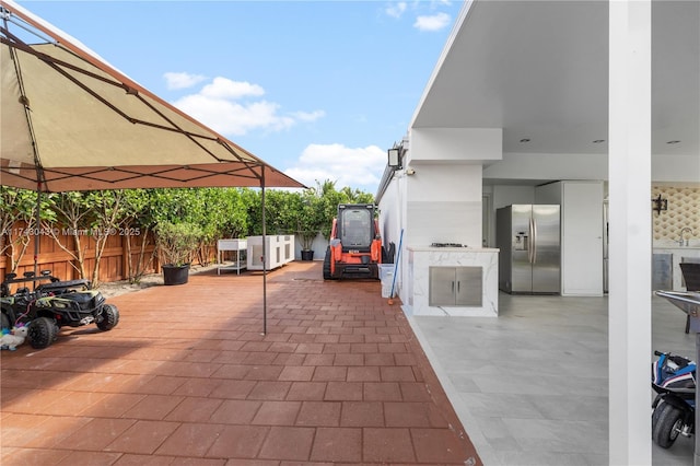view of patio with fence and area for grilling