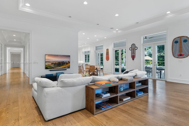 living room featuring ornamental molding, light hardwood / wood-style floors, and french doors