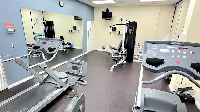 gym with a paneled ceiling