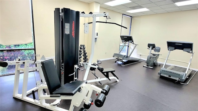 gym with a paneled ceiling