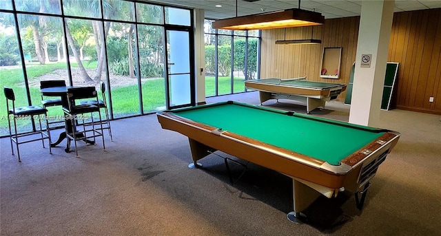 playroom featuring a paneled ceiling, billiards, wood walls, carpet floors, and floor to ceiling windows