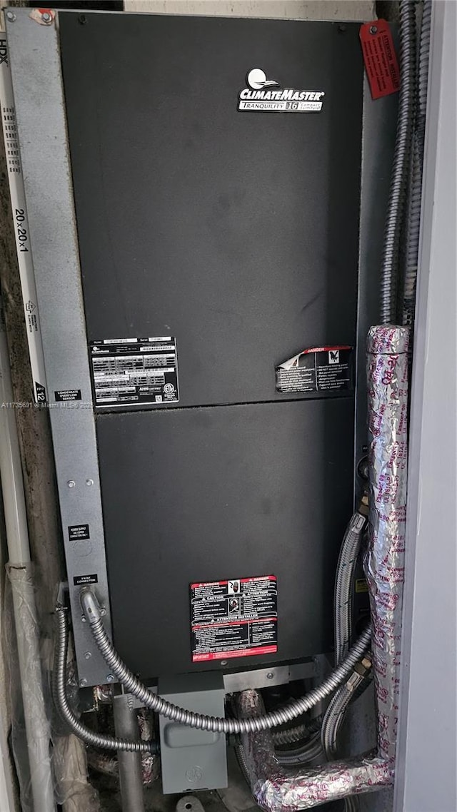 utility room featuring heating unit