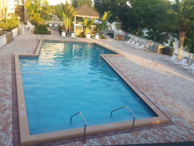 view of swimming pool featuring a gazebo and a patio area