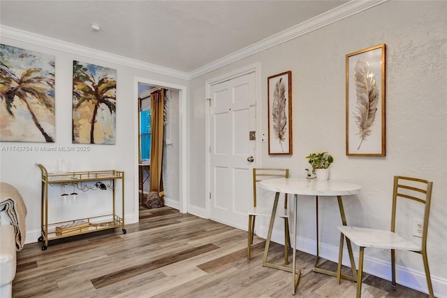 entrance foyer featuring hardwood / wood-style flooring and ornamental molding