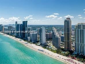 aerial view featuring a view of the beach and a water view