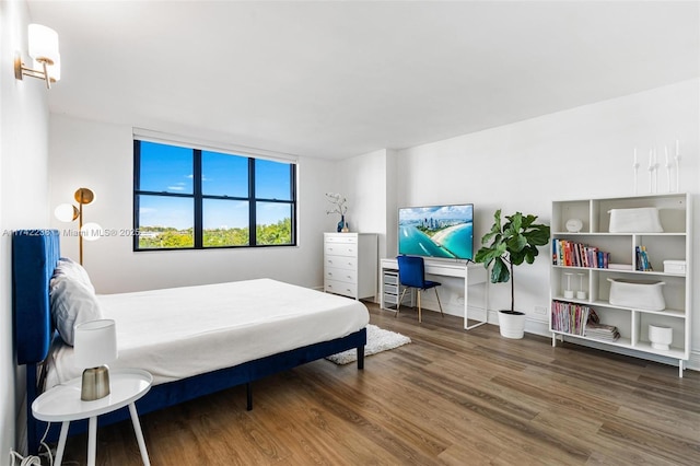 bedroom with dark hardwood / wood-style flooring