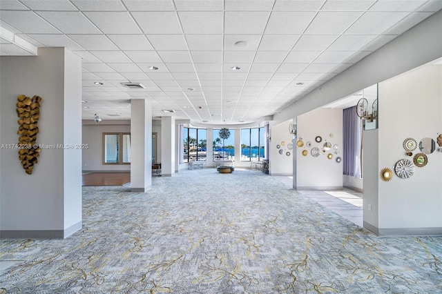 interior space with a paneled ceiling