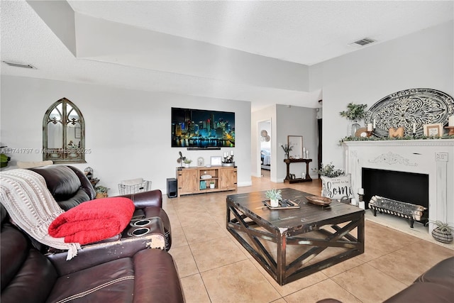 living room with light tile patterned flooring and a textured ceiling