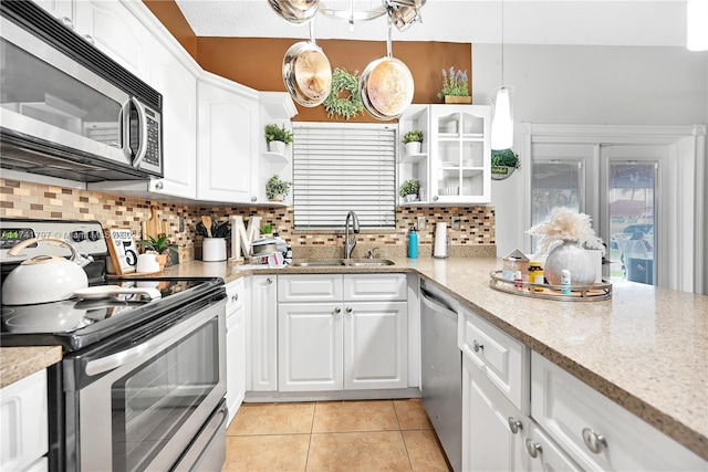 kitchen with white cabinetry, sink, hanging light fixtures, and appliances with stainless steel finishes