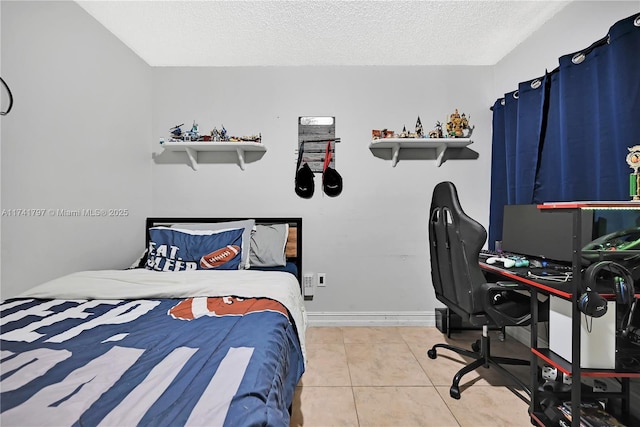 tiled bedroom featuring a textured ceiling