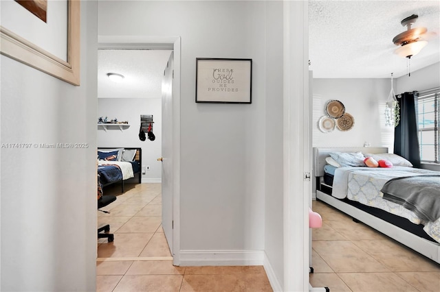 tiled bedroom with a textured ceiling