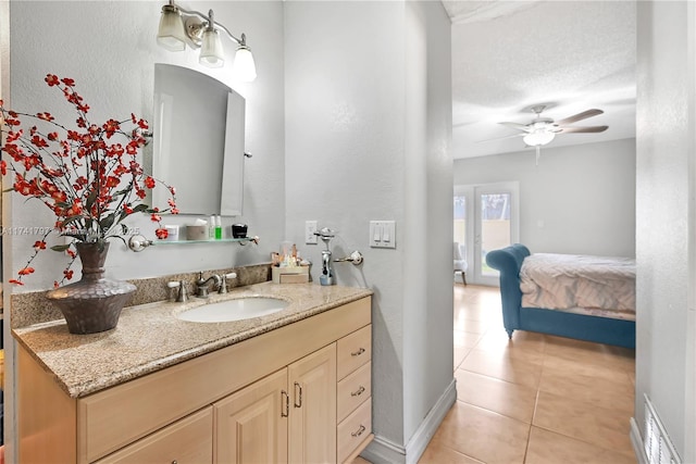 bathroom with ceiling fan, vanity, and tile patterned flooring