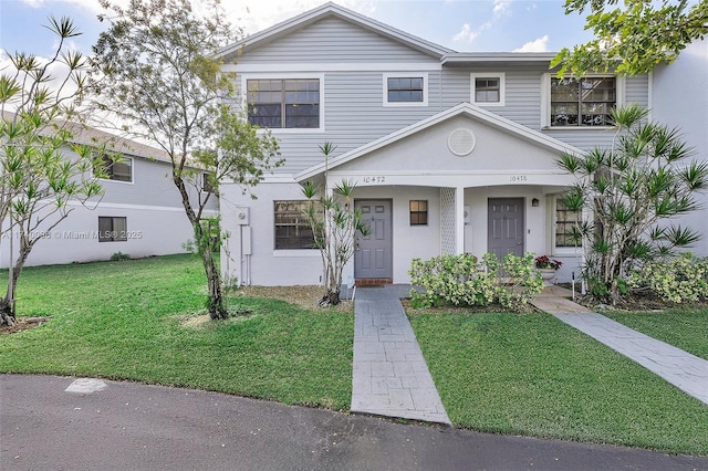 view of front of house featuring a front yard and stucco siding