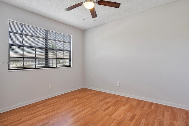 unfurnished room featuring a textured ceiling, ceiling fan, light wood-type flooring, and baseboards