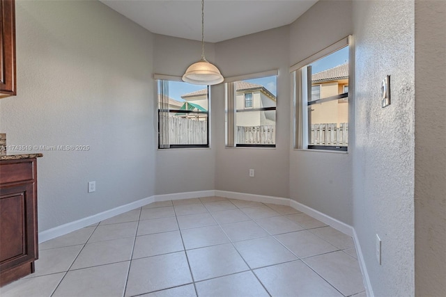 unfurnished dining area with light tile patterned floors