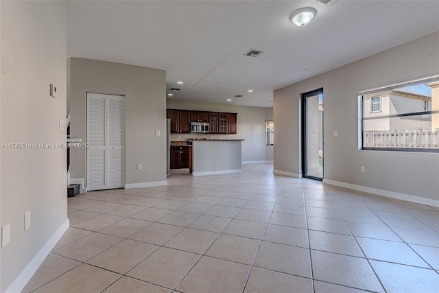 unfurnished living room featuring light tile patterned flooring