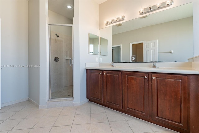 bathroom featuring tile patterned flooring, vanity, and walk in shower