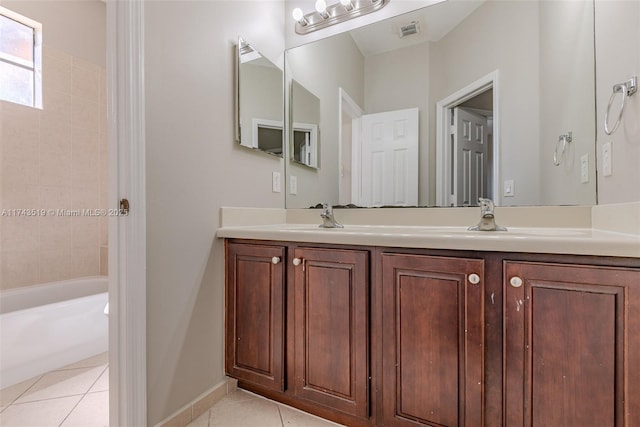 bathroom featuring vanity, tiled shower / bath combo, and tile patterned floors