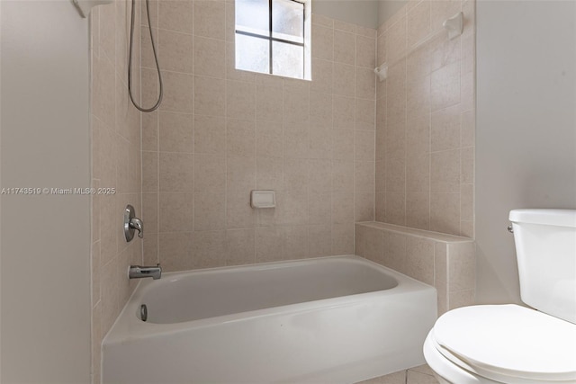 bathroom featuring toilet and tiled shower / bath combo