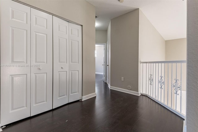 unfurnished bedroom with a closet and dark hardwood / wood-style floors