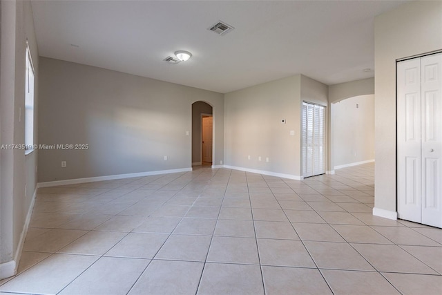 empty room with light tile patterned floors