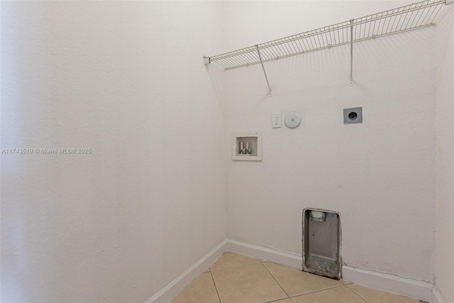 laundry room with hookup for a gas dryer, washer hookup, hookup for an electric dryer, and light tile patterned floors